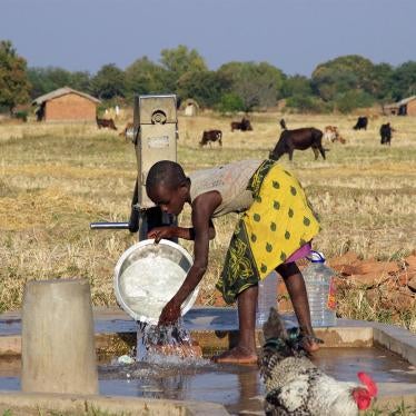 Young girl washing dishes at a borehole near Eland coal mine in Mwabulambo, Karonga district. 