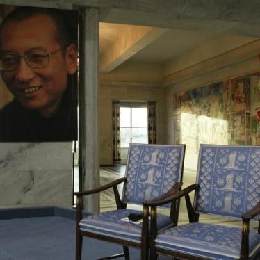 A picture of this year's Nobel Peace Prize laureate jailed Chinese dissident Liu Xiaobo is seen near an empty chair where he would have sat, during the Nobel Peace Prize ceremony at Oslo City Hall December 10, 2010. 