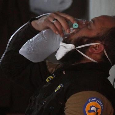 A civil defense member breathes through an oxygen mask, after what rescue workers described as a suspected chemical attack in the town of Khan Sheikhoun in rebel-held Idlib, Syria April 4, 2017.