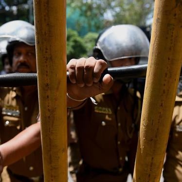 Sri Lankan police stand guard at a protest calling for the release of Tamil activists being held under the Prevention of Terrorism Act in Colombo, Sri Lanka, October 14, 2015.