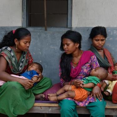 Women and girls wait with their children outside a doctor’s office in Chitwan, Nepal. 
