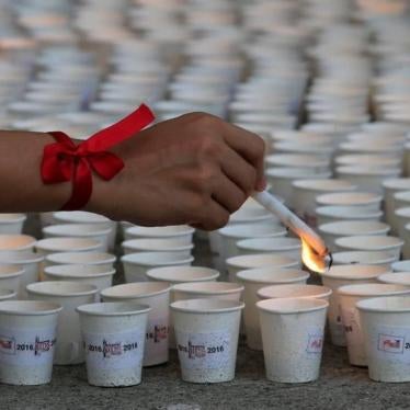 A supporter lights candles in commemoration of HIV/AIDS victims in the Philippines at a ceremony in Quezon City, Metro Manila, May 14, 2016. 