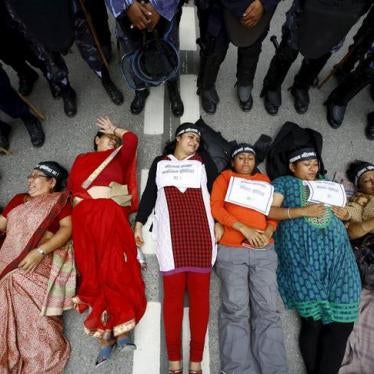 Women activists lie down on the road during a protest demanding women’s rights in the constitution in Kathmandu, Nepal, August 7, 2015.