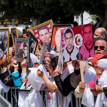 Families of those killed during the 2011 Tunisian revolution protest light sentences issued by military tribunals against former high officials in Tunis, April 16, 2014.