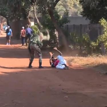 A man is beaten by a Zimbabwean soldier after protests broke out across the country on January 14, 2019.