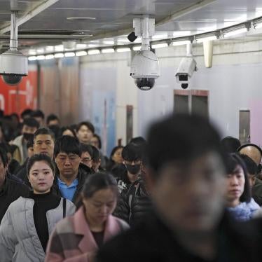Commuters walk by surveillance cameras installed at a walkway in between two subway stations in Beijing, Tuesday, Feb. 26, 2019. Chinese government has using the facial recognition to monitor people for it "social credit" system. 