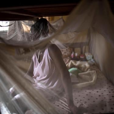 A woman from Cameroon sits with her baby in a private shelter in Lagos, Nigeria.