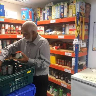 Abdalkarim Sama, a volunteer at Sufra Food Bank, sorts through tinned food in the storage section on site at Sufra Food Bank, in Brent, Northwest London. October 9, 2019