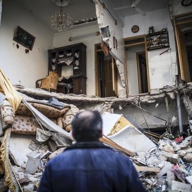 A civilian looks at a destroyed home in Aleppo, Syria, January 3, 2013. © 2013 AP Photo/Andoni Lubaki