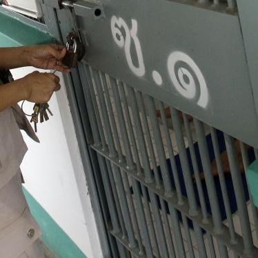 An officer locks a cell at a prison in Thailand, February 2017. © 2017 AP Photo/Sakchai Lalit
