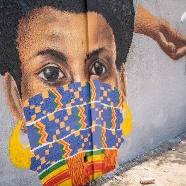 A member of the Senegalese graffiti collective "RBS CREW" paints informational murals advising how to stop the spread of the new coronavirus, on the wall of a high school in the Parcelles Assainies neighborhood of Dakar, Senegal, March 25, 2020. 
