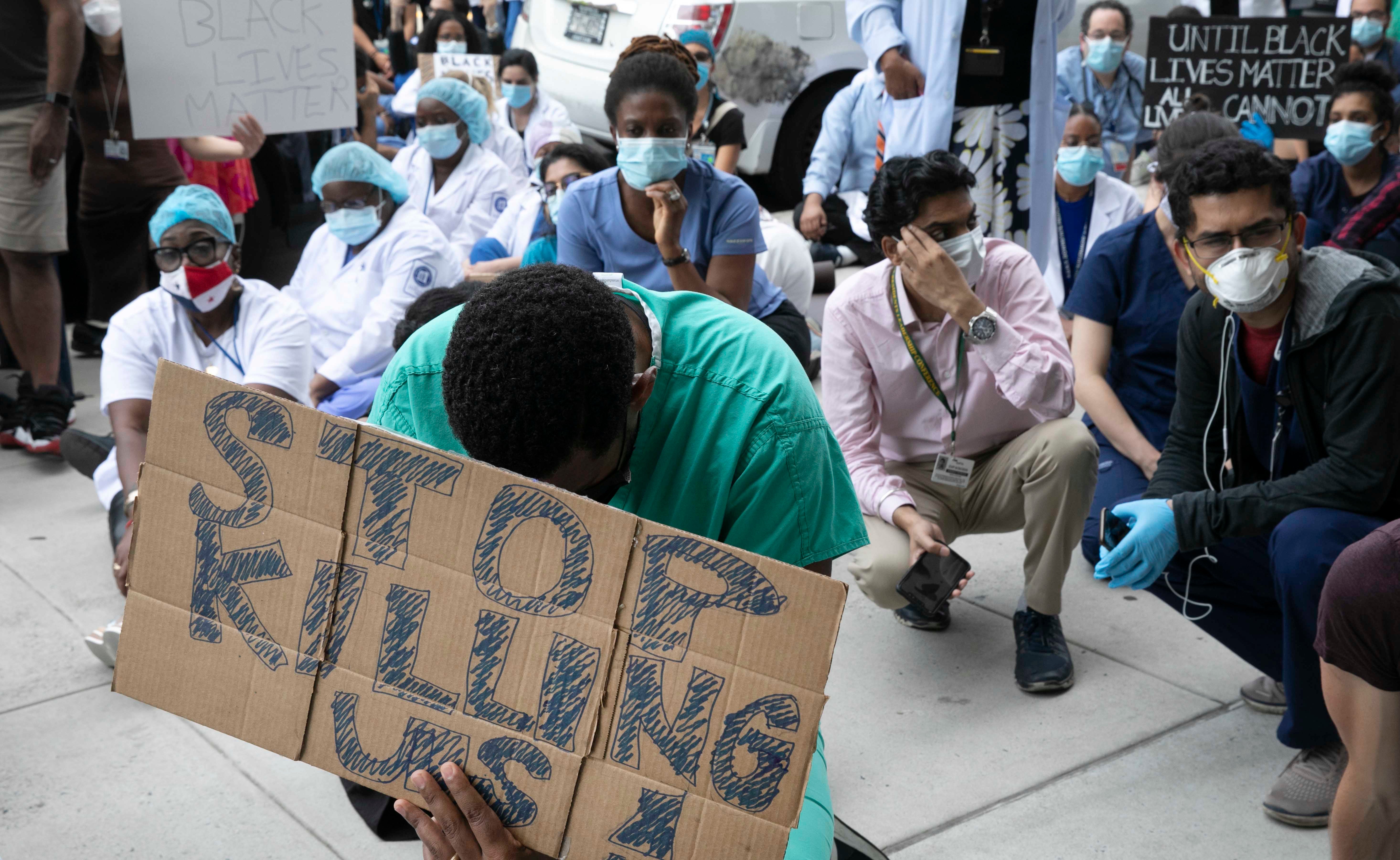 Healthcare workers at Brooklyn's Kings County Hospital show their solidarity with the Black Lives Matter movement during the coronavirus pandemic, New York, June 4, 2020.