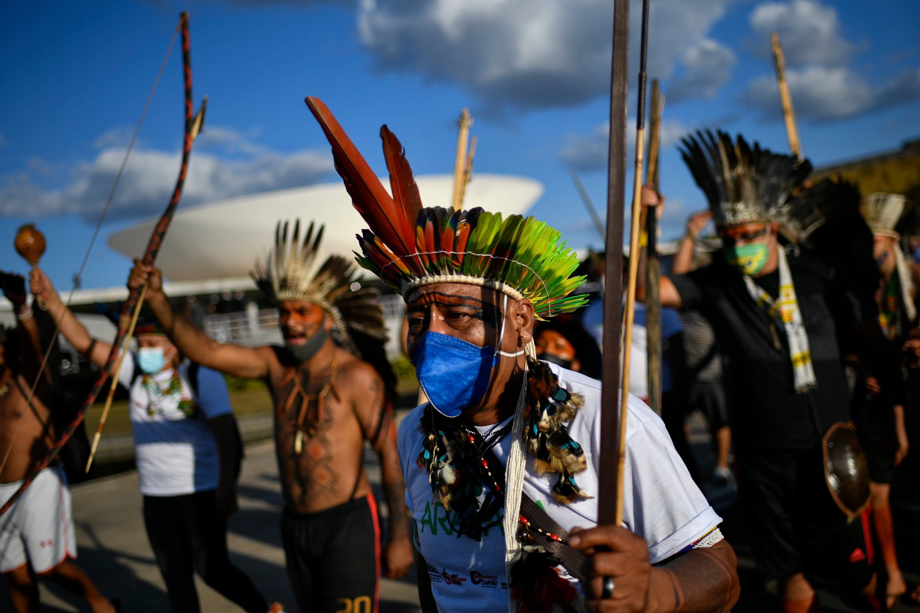 Indigenous people protest against a bill on the demarcation of indigenous land, on the roof of the National Congress, on June 8 2021, in Brasilia, Brazil. Photo: Mateus Bonomi/AGIF (via AP)
