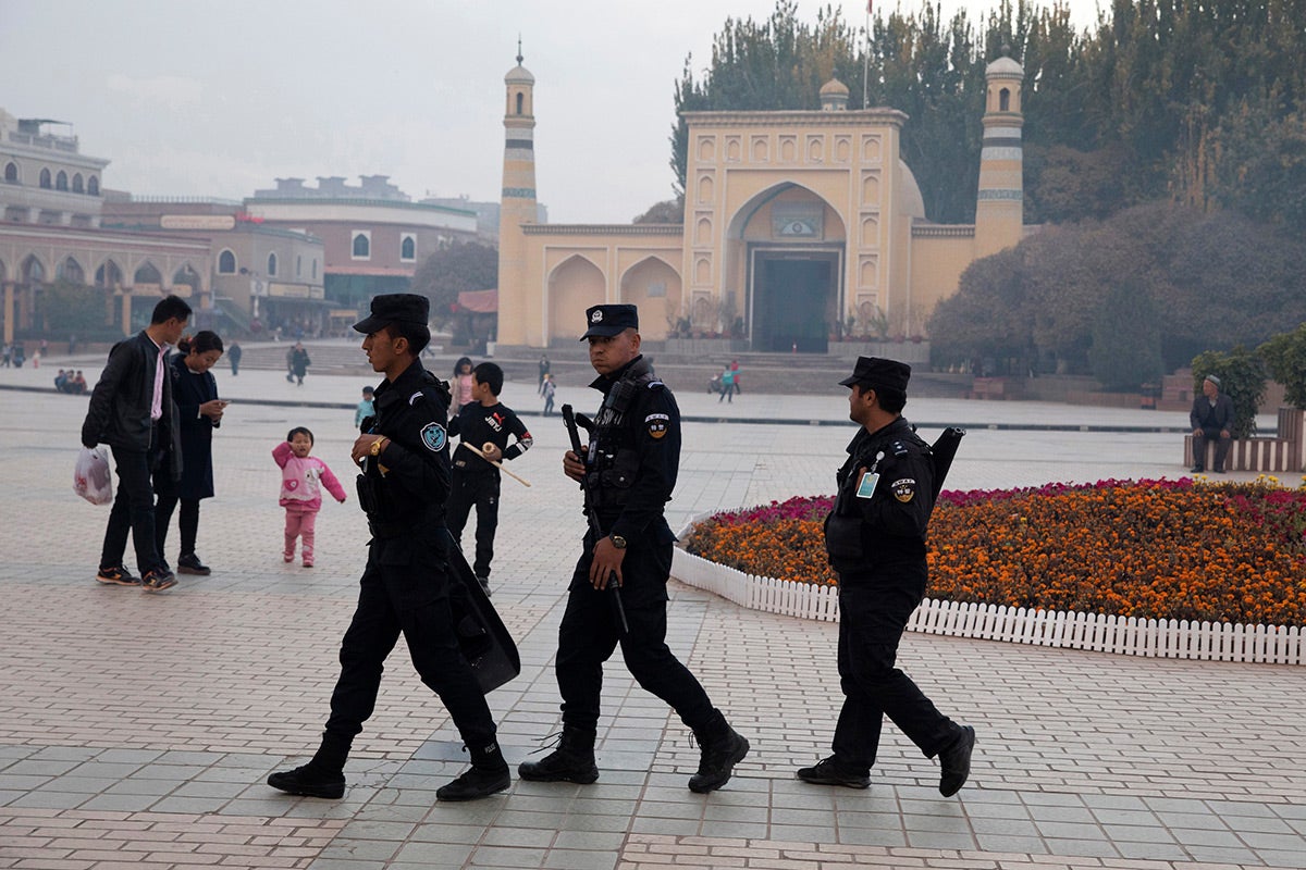 Chinese security personnel patrol near the Id Kah Mosque in Kashgar in China's Xinjiang region, November 4, 2017.