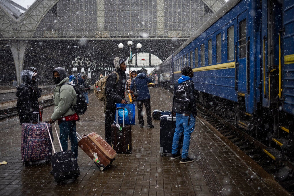 Nigerian students in Ukraine wait on a platform in Lviv railway station for a train to evacuate across the border, Sunday, February 27, 2022 in Lviv, west Ukraine.