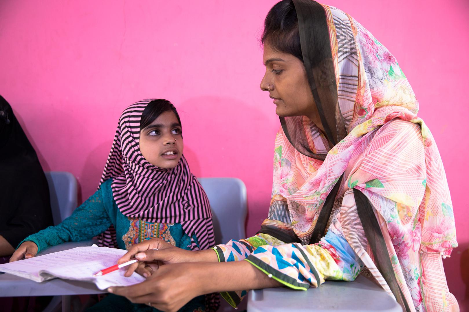 Laiba, age eight, with Shazia, the founder of the lyari School. 