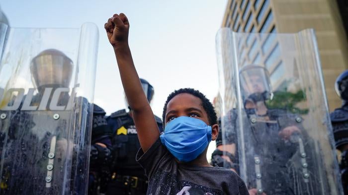 A young boy raises his fist during a demonstration in Atlanta, Georgia, May 31, 2020.
