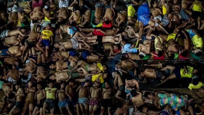 Detainees sleep in an open basketball court inside the Quezon City Jail in Quezon City, Philippines on July 24, 2020. 