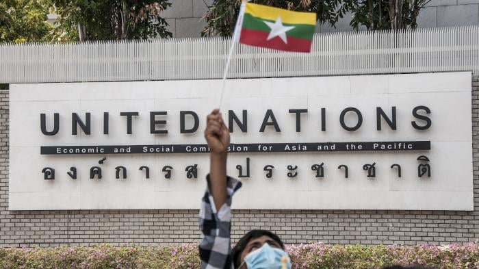 A protester waving a Myanmar nation flag in front of the United Nation building during the demonstration.