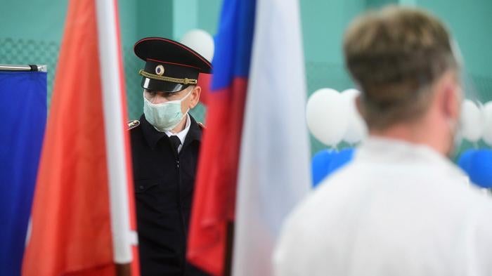 Police officer wearing face mask stands on duty at the polling station on July 1, 2020 in St. Petersburg, Russia.