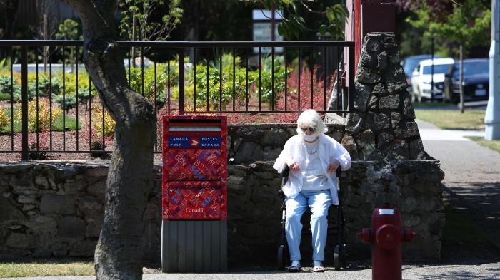 A woman sits to take a rest as heat wave hits Western Canada on June 30, 2021 in Victoria, British Columbia, Canada. © 2021 Mert Alper Dervis/Anadolu Agency via Getty Images