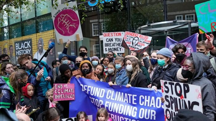 Climate activist Greta Thunberg, center, demonstrates with others in front of the Standard and Chartered Bank during a climate protest in London, England, October 29, 2021