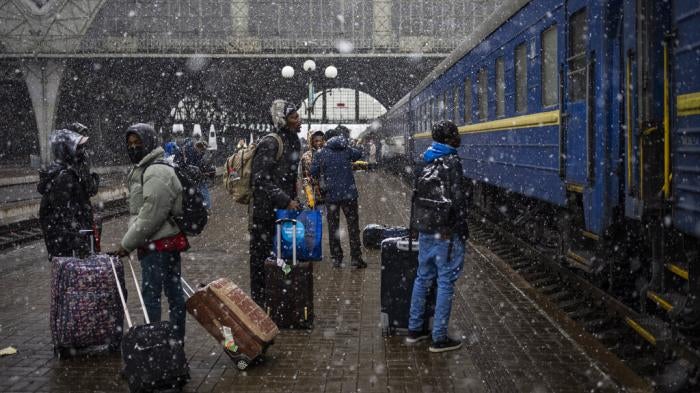 Nigerian students in Ukraine wait on a platform in Lviv railway station for a train to evacuate across the border, Sunday, February 27, 2022 in Lviv, west Ukraine.