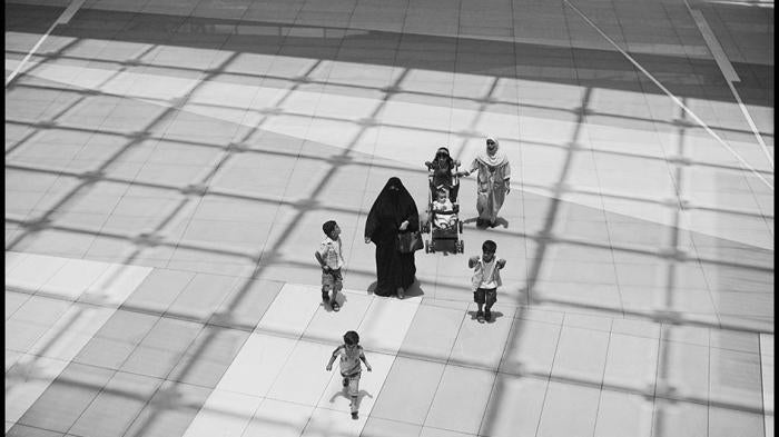 A female employer and her children are accompanied by their domestic worker, back right, as they walk through The Avenues, an indoor luxury shopping center in Kuwait City. 
