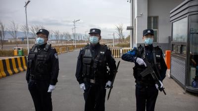 Police officers stand at the outer entrance of the Urumqi No. 3 Detention Center in Dabancheng in western China's Xinjiang region on April 23, 2021.