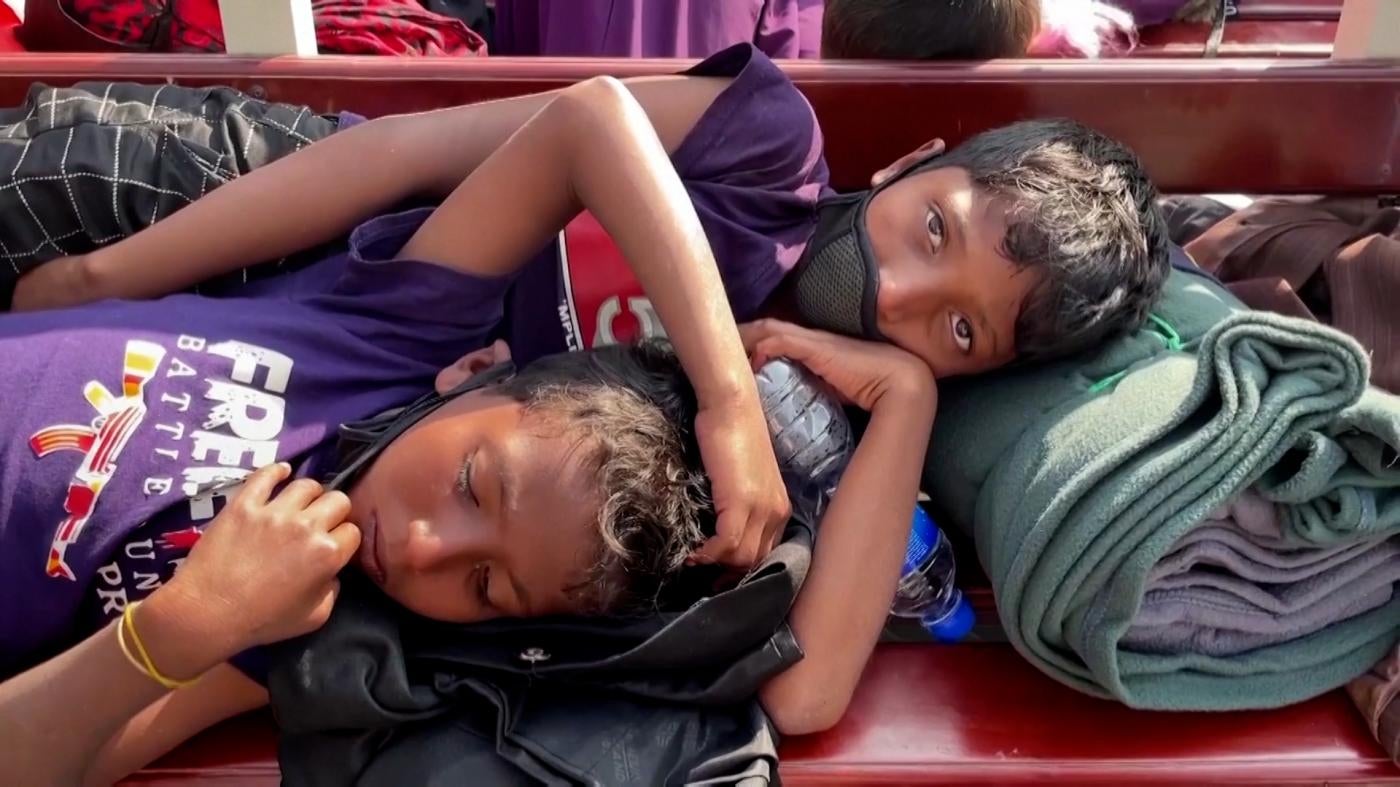 Two Rohingya boys laying down on ship to Bhasan Char