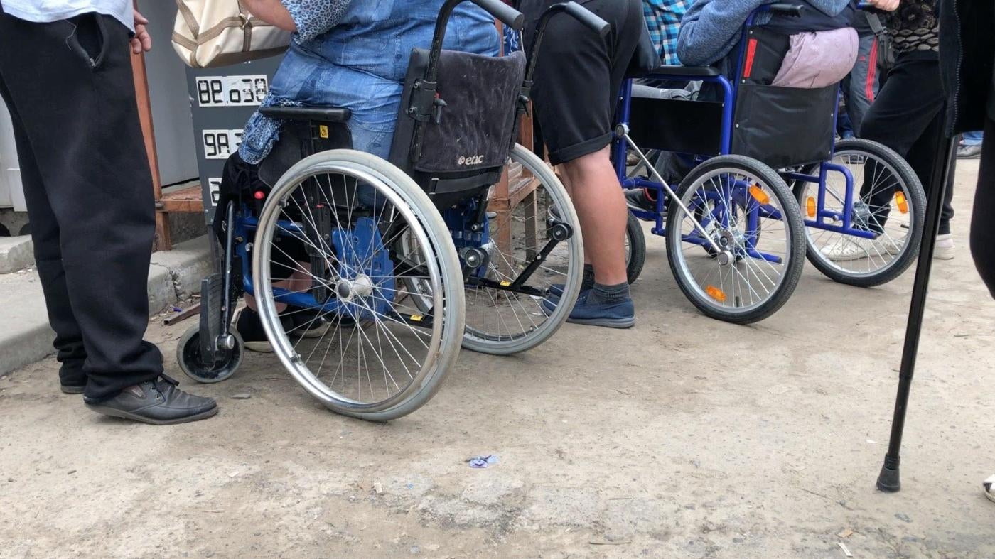 People in wheelchairs at a checkpoint in Eastern Ukraine