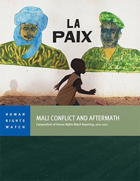 A boy in Timbuktu runs in front of a mural that reads “Peace,” a few days before the July 2013 presidential elections in Mali.