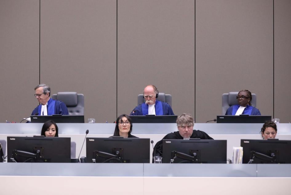Marc Perrin de Brichambaut, Péter Kovács, and Reine Alapini-Gansou are the three pre-trial chamber judges assigned to the Palestine situation at the International Criminal Court (ICC). The photo shows them in an ICC hearing related to Mali on July 8, 2019.