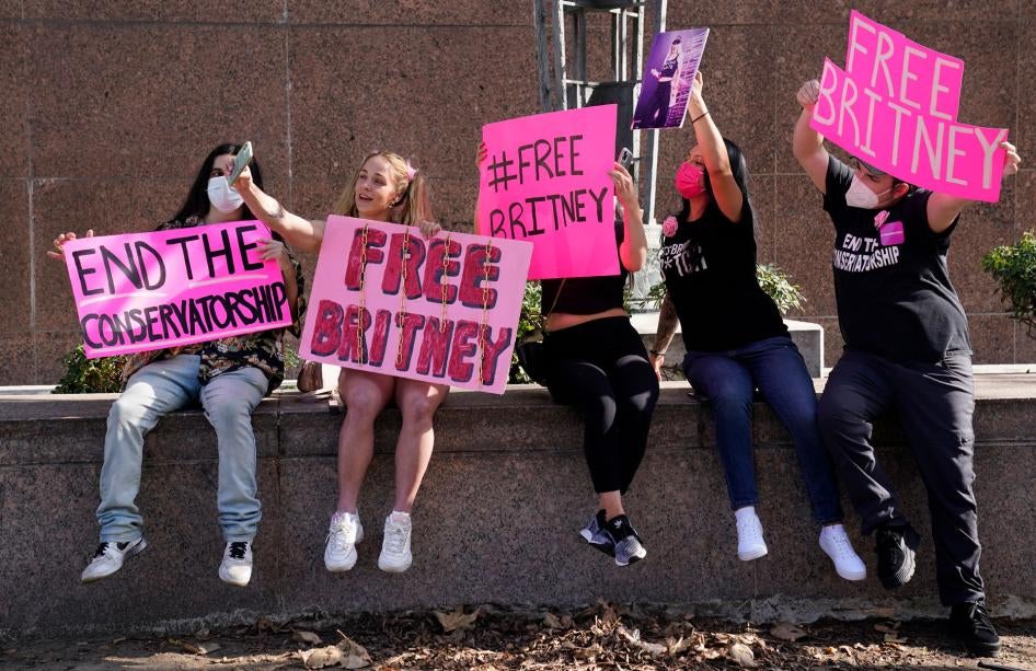 Britney Spears supporters pose for a photo outside a court hearing concerning the pop singer's conservatorship at the Stanley Mosk Courthouse in Los Angeles, February 11, 2021.