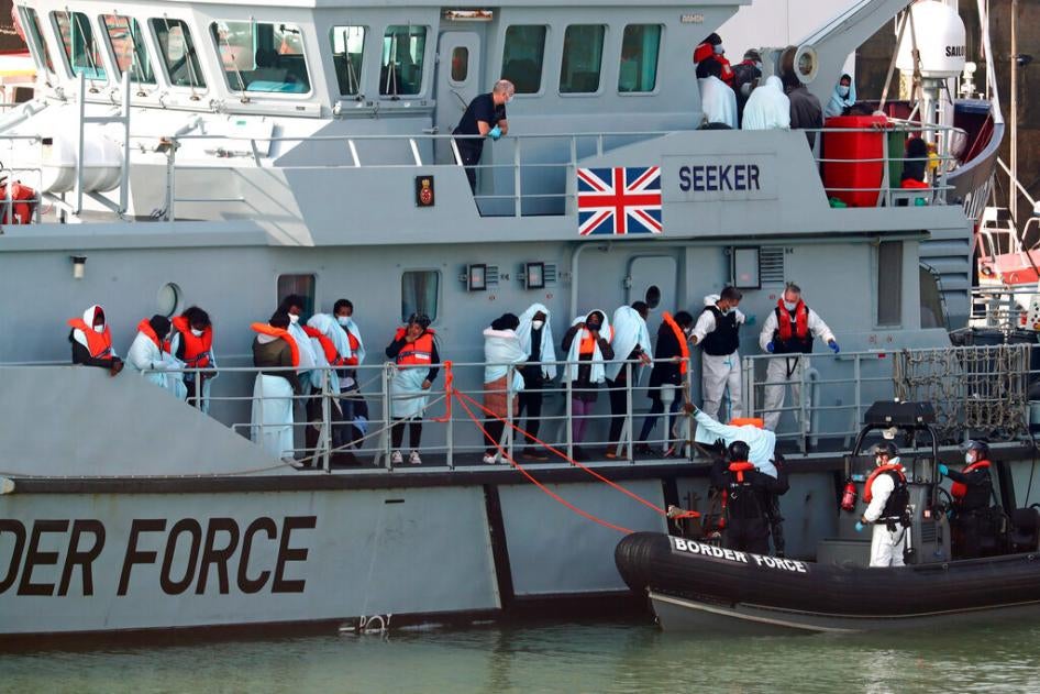 A group of people on the deck of HMC Seeker as they wait to be brought ashore by the UK Border Force in Kent. September 22, 2020.