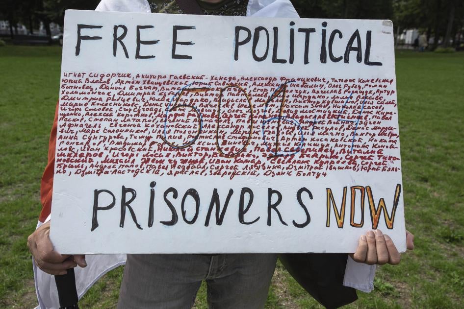 In The Hague, Netherlands, on August 7, a demonstrator holds a placard showing the names of some of those arbitrarily detained in Belarus for protesting against President Alexander Lukashenko, and calling for their release.