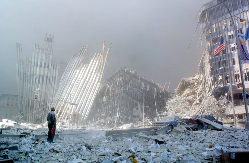 A man stands in the rubble after the collapse of the first World Trade Center Tower in New York City on September 11, 2001.