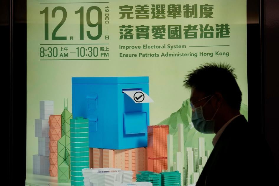 一名男子在将举行的香港立法会选举宣传海报前走过，2021年11月23日。