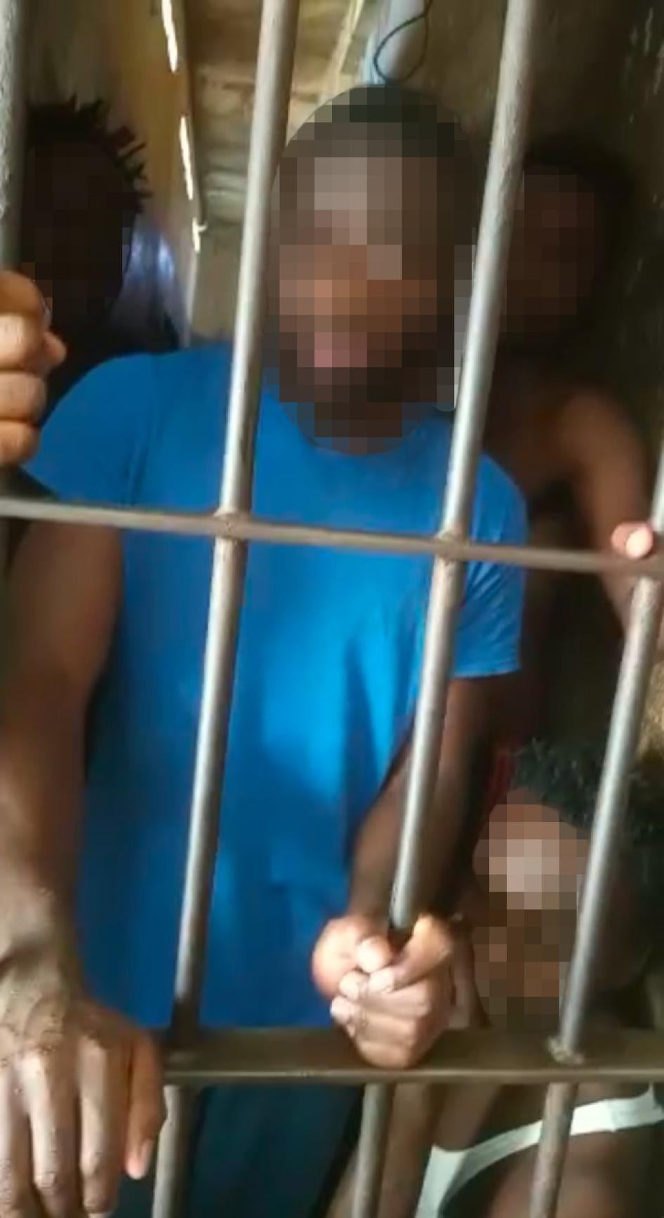 People behind bars with their faces blurred