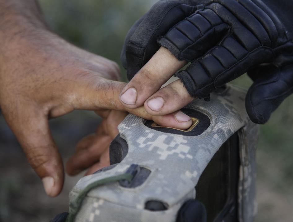 A United States military official takes the fingerprints of a man in Afghanistan