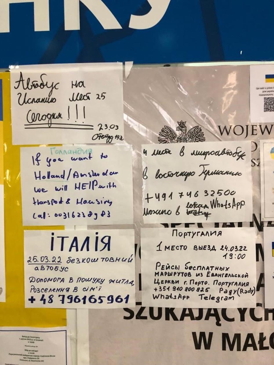 Handwritten signs outside an information point for refugees at Krakow’s central train station advertising private transport to and accommodation in Italy, Spain, Germany and Portugal, March 24, 2022. 