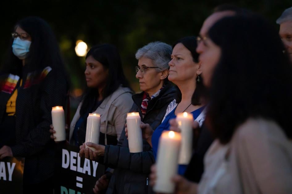 Activists hold a candlelight vigil
