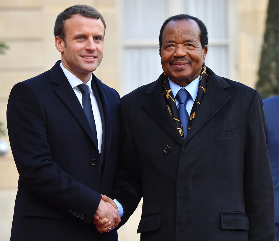 French President Emmanuel Macron greets Cameroon President Paul Biya at the Elysee Palace in Paris, France, on December 12, 2017, as part of the One Planet Summit.
