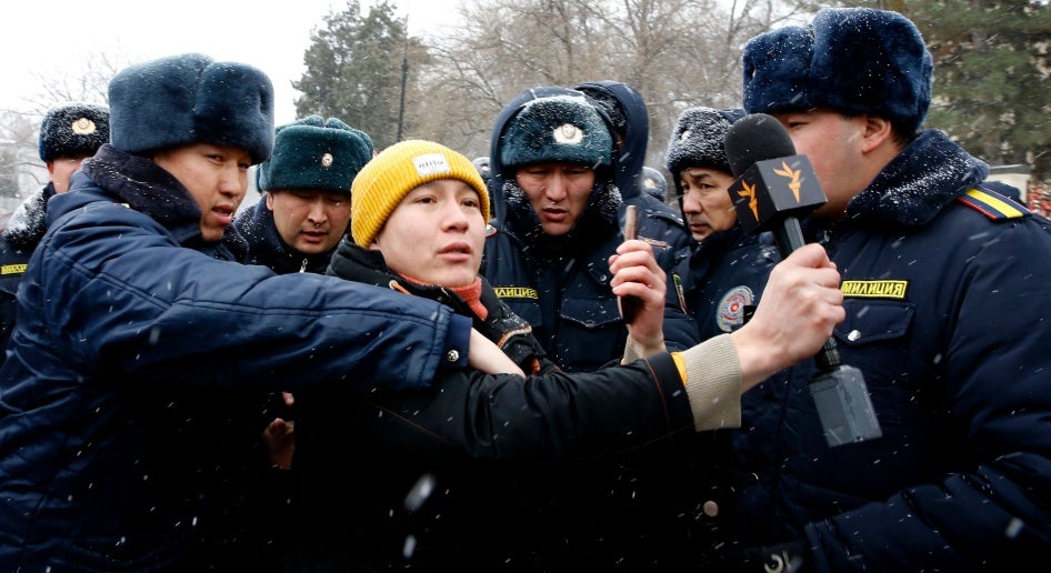 Police officers detain a journalist covering a protest near the government building in Bishkek, Kyrgyzstan, January 10, 2023. Protesters demanded the release of detained members of the so-called Kempir-Abad reservoir support committee.