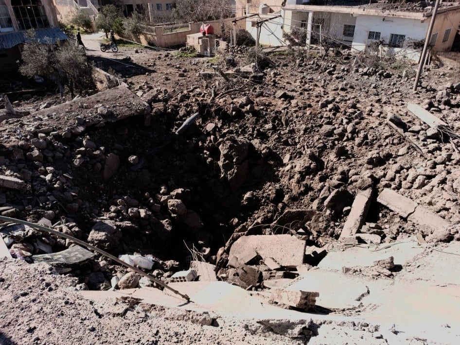 Destruction to a cluster of four houses in Orman town. A large crater is visible on the south part of the cluster where a house stood and was completely destroyed.