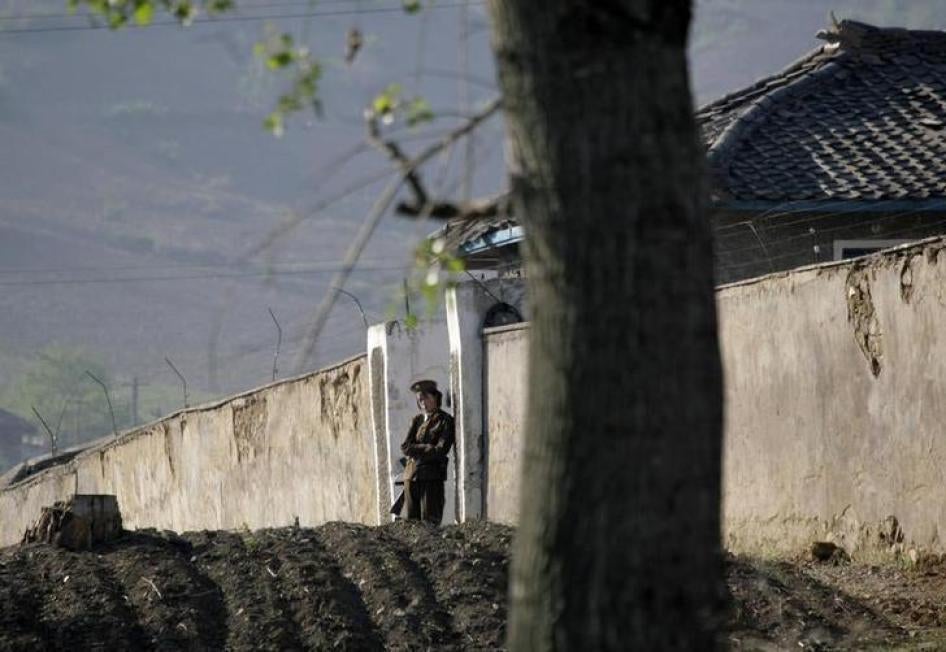 A North Korean soldier stands guard at the entrance of a women’s prison near Chongsong, North Korea, May 31, 2009.