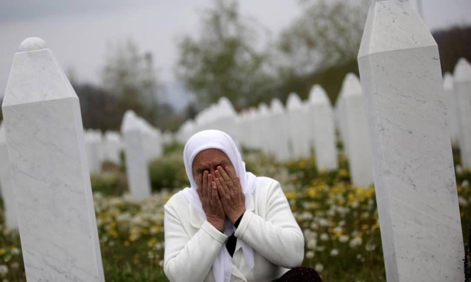 Mejra Dzogaz cries near the graves of her family members at the Memorial Center in Potocari, Bosnia and Herzegovina, 6 km north-west of Srebrenica, on April 7, 2014. Dzogaz lost her three sons, husband and father in the Srebrenica massacre. 