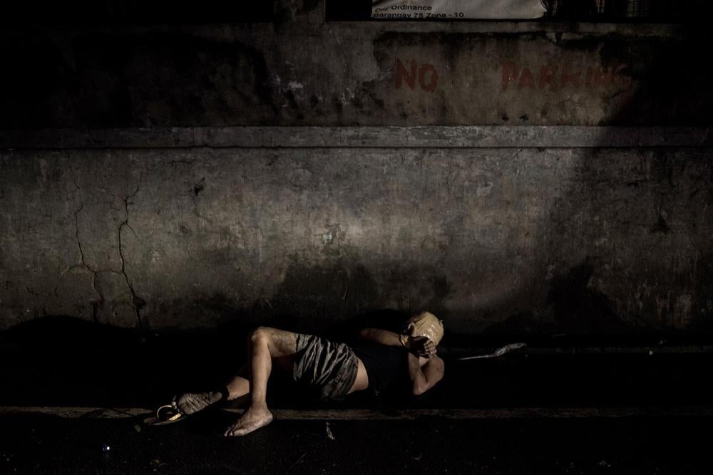The body of an unidentified man with face wrapped in packaging tape and hands tied found dumped in a narrow street in Pasay, Metro Manila, November 2016.