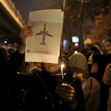 In this January 11, 2020, people gather for a candlelight vigil to remember the victims of the Ukraine plane crash at the gate of Amir Kabir University in Tehran, Iran.