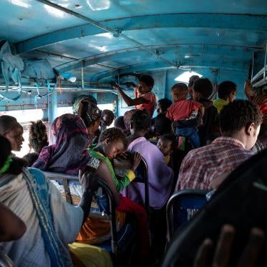 People who fled the conflict in Ethiopia's Tigray region ride a bus to the Village 8 temporary shelter near the Sudan-Ethiopia border, in Hamdayet, eastern Sudan, December 1, 2020. 